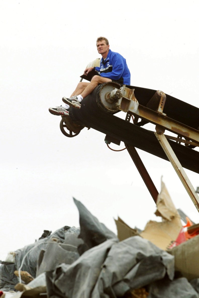 19/03/2003 
North Kangaroos coach Dean ''The Junk Yard Dog'' Laidley use to love a scrap on the ground as a player. Here on top of garbage conveyor. Digital Image. Football.